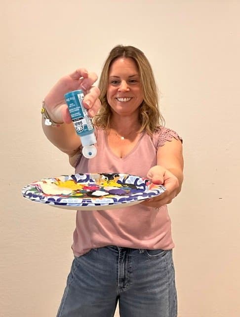 Hannah mixing paint on a palette