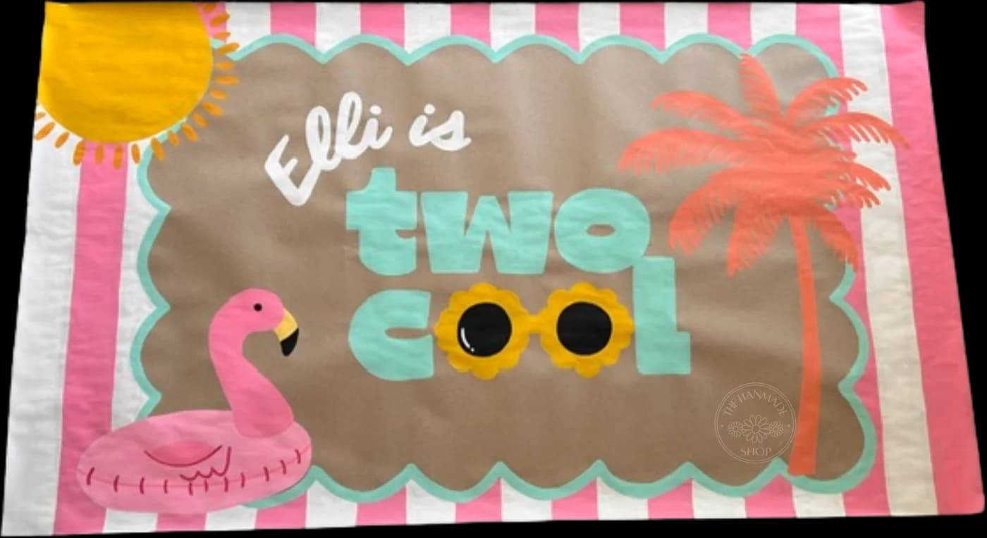 Hand-painted birthday banner peeking out behind the main photo, reading Elli is Two Cool